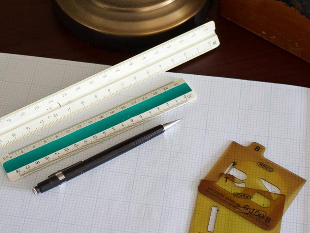 ruler and pencil sitting on a page