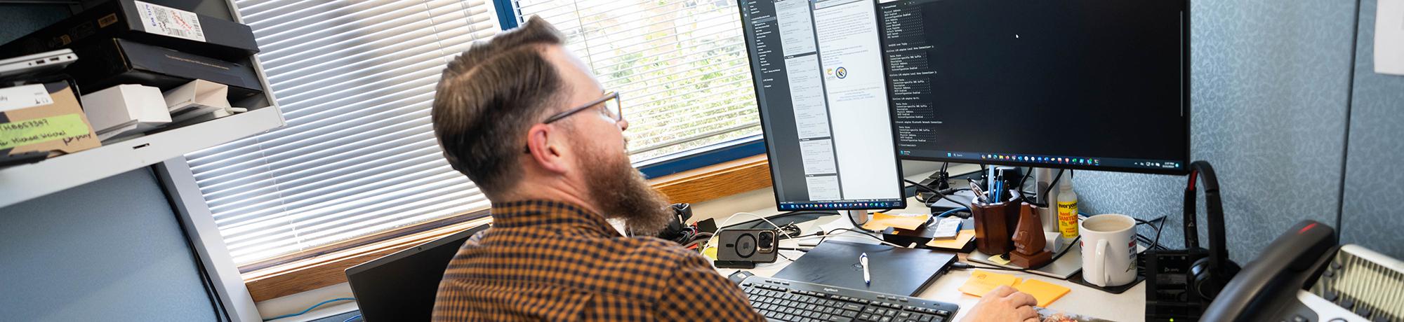 man working at computer workstation