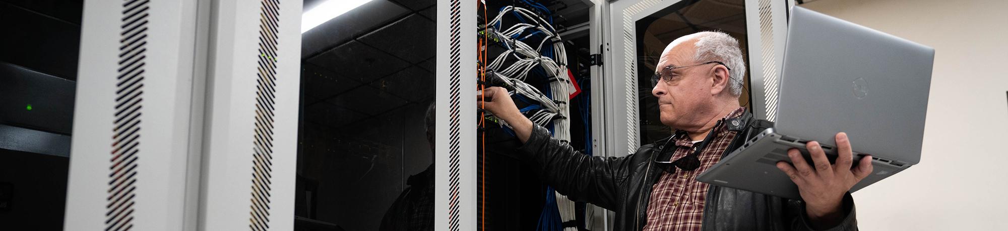 man working on computer system network