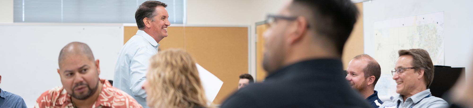  man presenting to a room of people